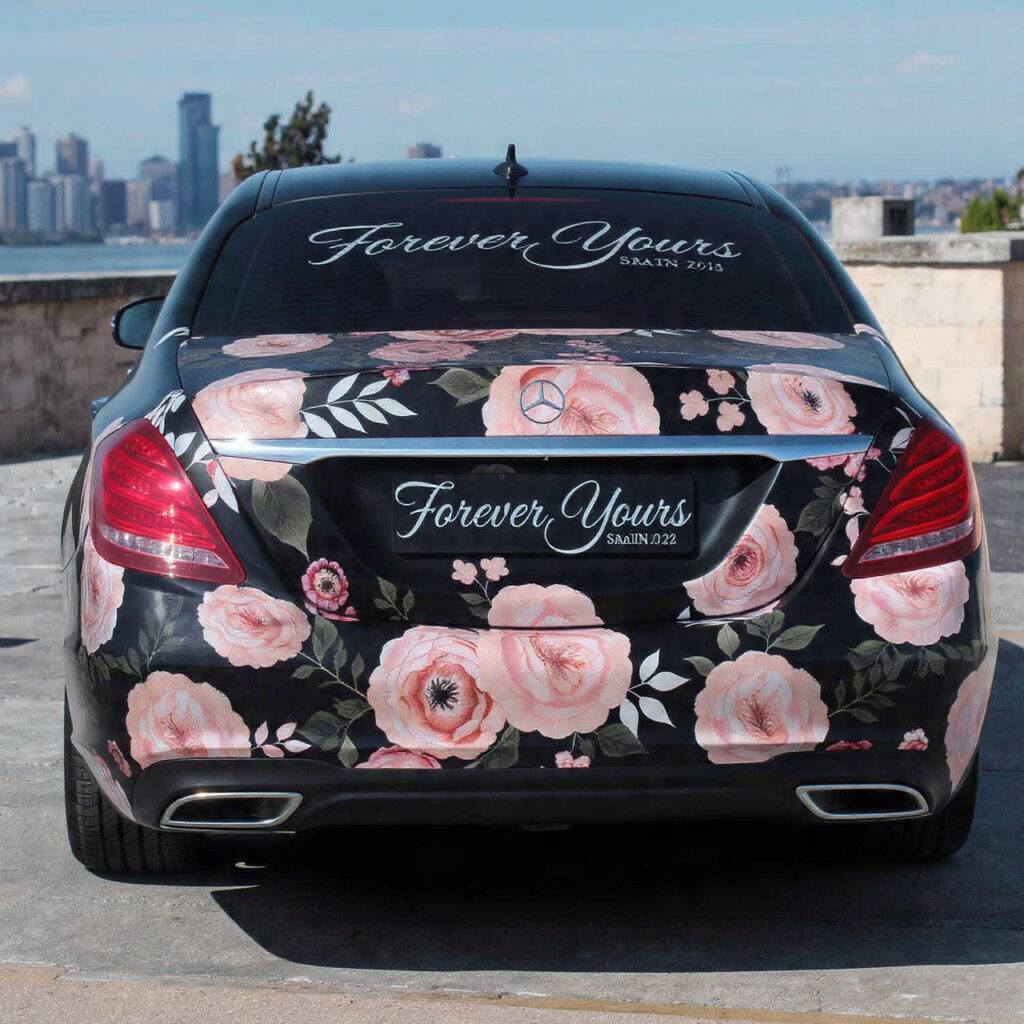 wedding car covered in a temporary floral