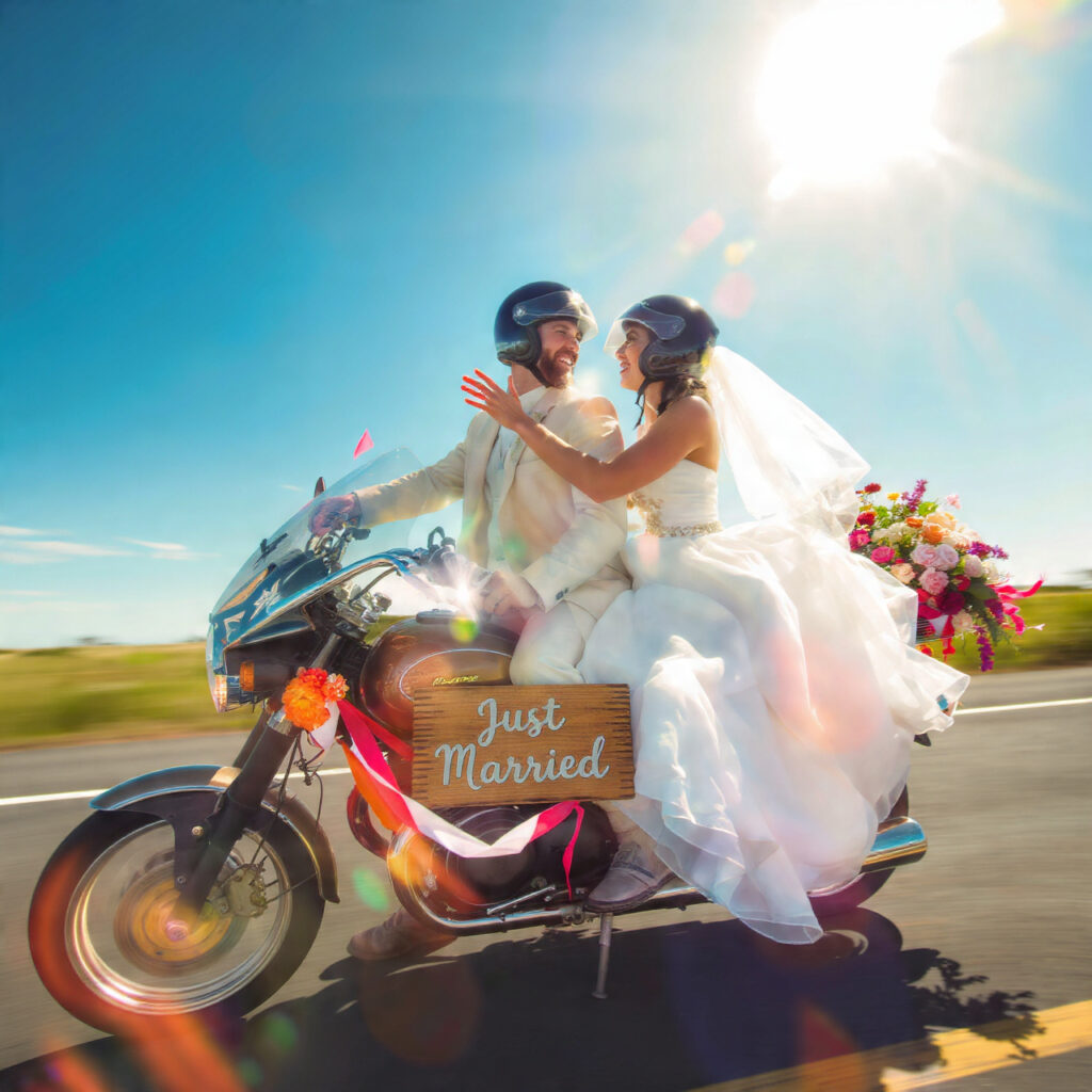 bride and groom wearing helmets riding off