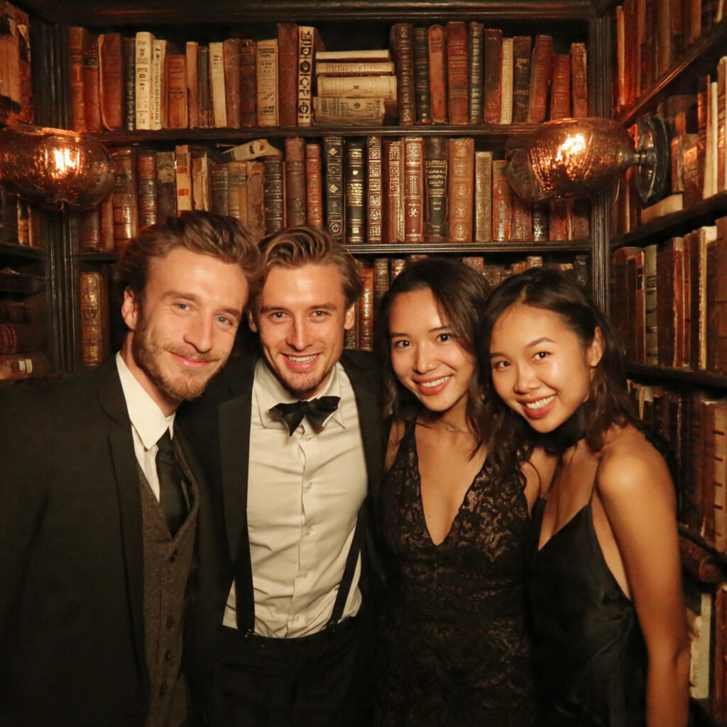 wedding photobooth with wall of books backdrop